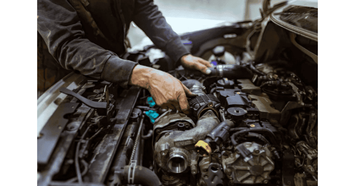 Mecanicien qui travaille sur le moteur lors du changement de turbo d une voiture
