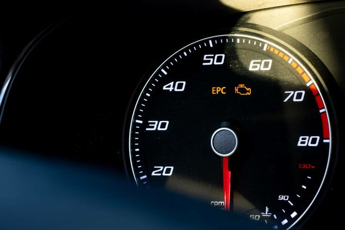 Gros plan sur un compteur de voiture avec les voyants EPC et moteur allumés