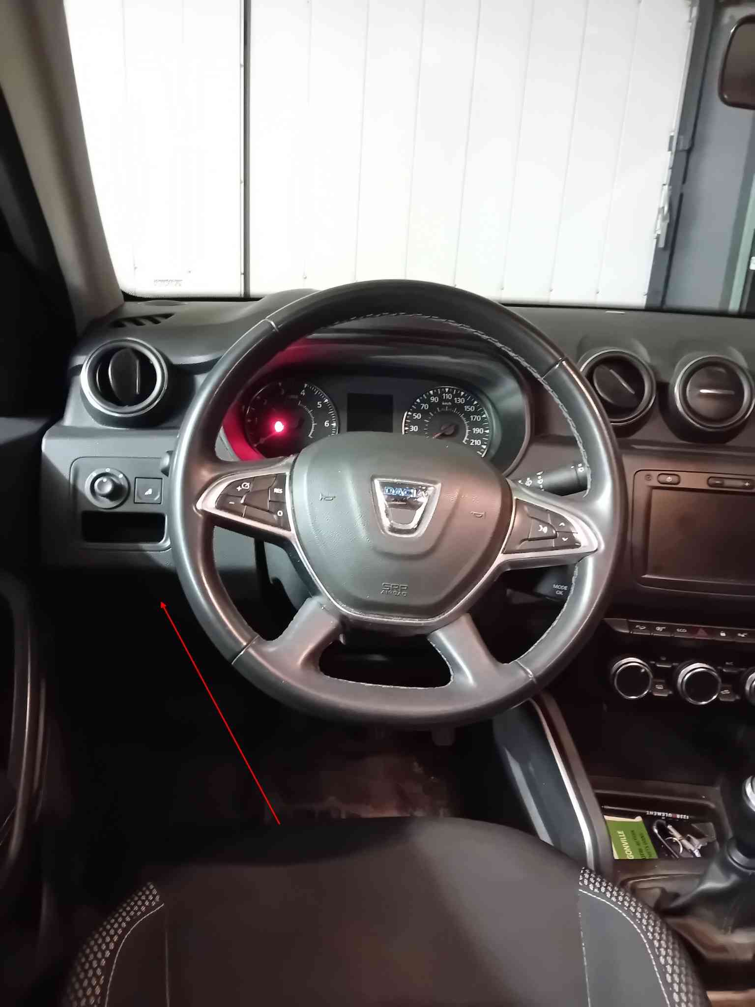 Emplacement de la prise de diagnostic OBD sous le volant d un Dacia Duster 2