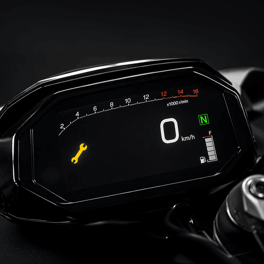 Voyant orange de clé plate allumé sur le tableau de bord LCD d une moto à l arrêt